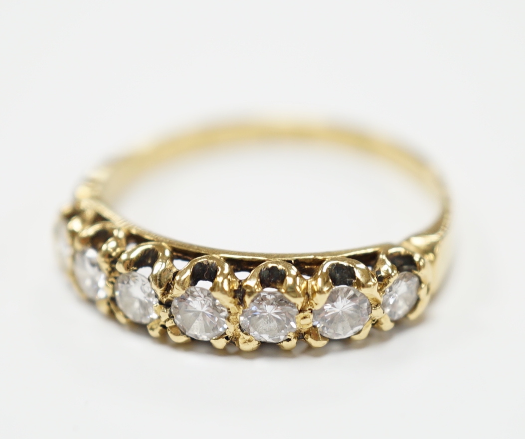 An 18ct gold and seven stone diamond set half hoop ring, size P, gross weight 2.7 grams.